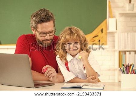 father and son study in classroom with laptop, school