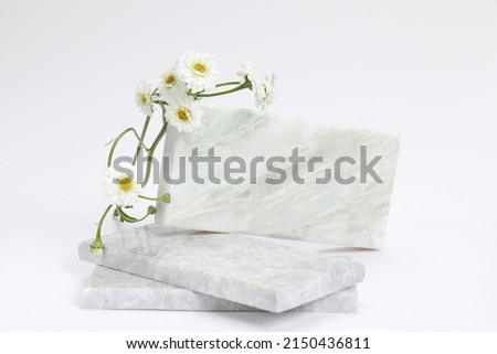 Stone podium, Cosmetic display stand with daisy blossom flowers on brown background. 3D rendering