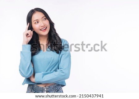 Positive Asian woman think choice creative on white background. Smile girl thinking about question, pensive expression something over isolated. Lady thoughtful doubt holding finger on head looking up. Royalty-Free Stock Photo #2150437941