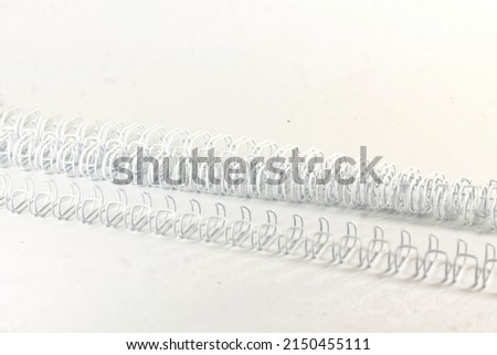 long white spiral wire on an isolated white background. copy space for is used to bind books, documents, calendars and photos. Royalty-Free Stock Photo #2150455111
