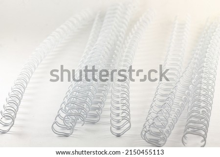 white spiral wire on an isolated white background. copy space for is used to bind books, documents, calendars and photos. Royalty-Free Stock Photo #2150455113
