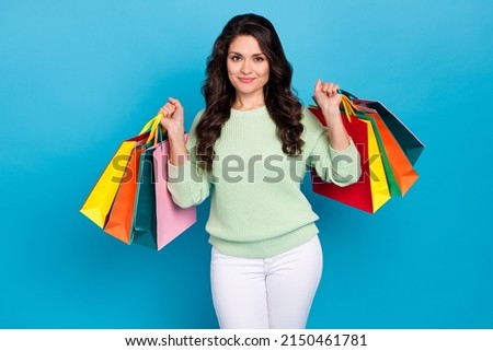 Photo of cute mature brunette lady go shoping wear green sweater isolated on blue color background Royalty-Free Stock Photo #2150461781