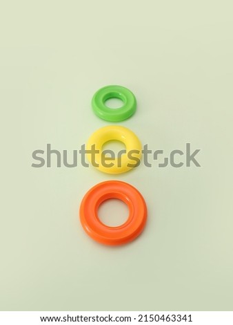 Colorful plastic rings on green background