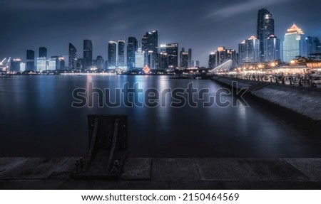 On the river the neon lights of the city are reflected Royalty-Free Stock Photo #2150464569