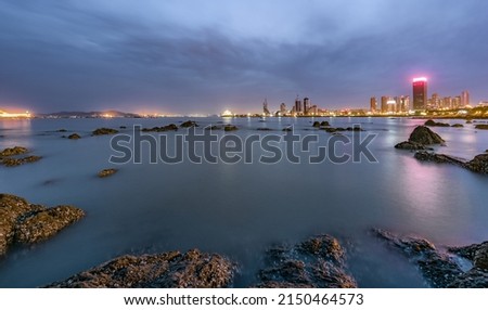On the river the neon lights of the city are reflected Royalty-Free Stock Photo #2150464573