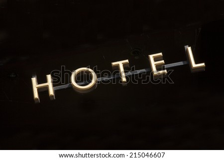 Gold Hotel Sign on Black Background