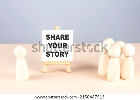 SHARE YOUR STORY text on a easel with wooden figure, meeting concept