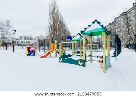 playground with slides in the yard in winter