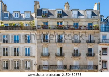Paris, typical facade, beautiful building in the center with an hotel sign