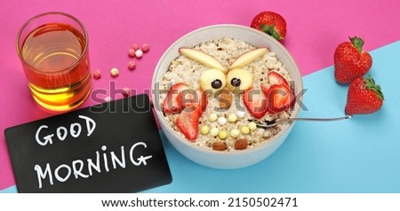 Creative oatmeal breakfast for kids on colourfull background. Healthy breakfast idea. Playful lunch. Top view, flat lay, copy space, panorama