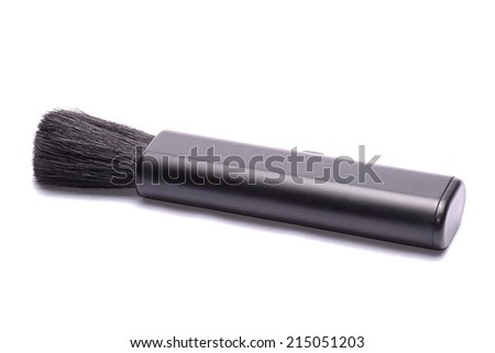 Lens brush for cleaning camera on a white background