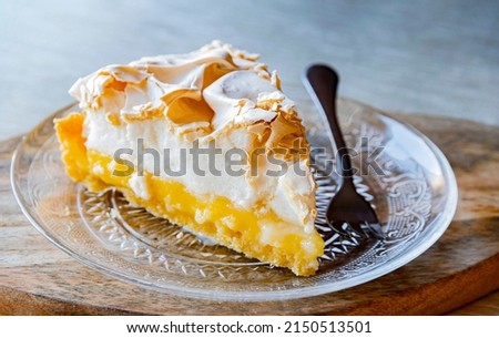 A plate with a lemon meringue tart.