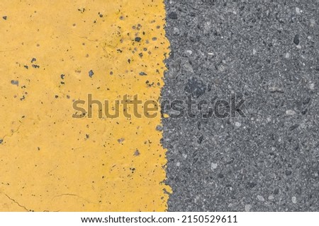 Asphalt street road markings with yellow paint abstract background design pattern.