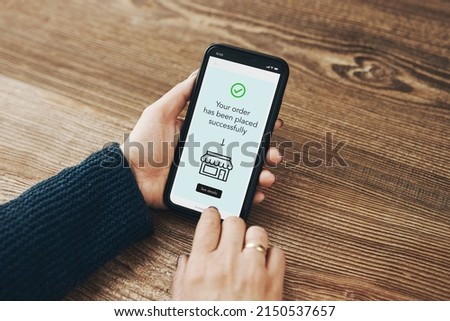 Shopping online. Ordering product online using smartphone. Female hands using smartphone for online shopping. Order confirmation - thank you. Your order has been placed successfully - displayed in app Royalty-Free Stock Photo #2150537657
