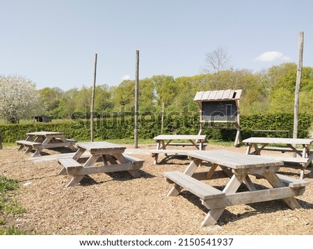 Outdoor classroom with wooden picnic tables for vegetable garden lesson