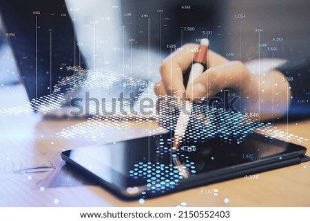 Close up of hand at workplace using tablet with pen and abstract digital map and index lines on blurry background. Global infographic, world and location concept. Double exposure
