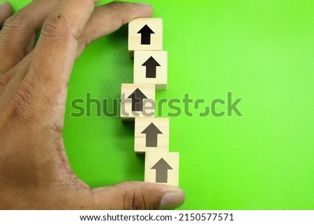wooden cubes with the direction of following the winding arrow. concept towards success
