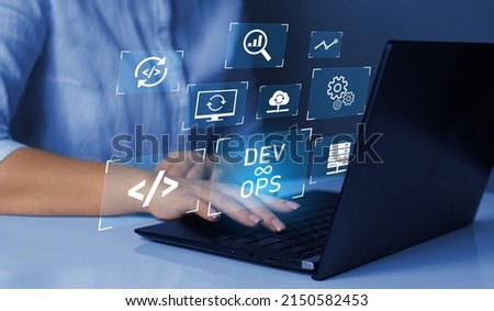 Agile programming and DevOps concept. Engineer working on laptop with virtual screen. IT operations, high software quality and software development. Royalty-Free Stock Photo #2150582453