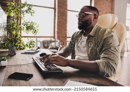 Profile side view portrait of attractive focused guy expert typing remote technical support at workplace workstation indoors Royalty-Free Stock Photo #2150584655