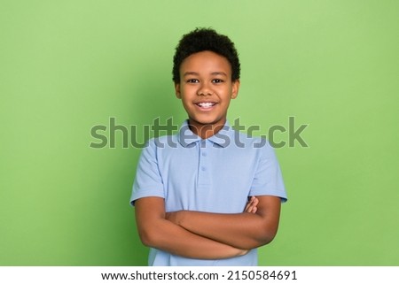 Portrait of attractive cheerful content pre-teen schoolkid folded arms lesson isolated over green color background Royalty-Free Stock Photo #2150584691