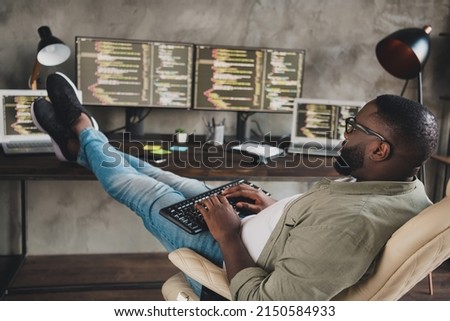 Profile side view portrait of attractive focused skilled guy expert technician editing code at workplace workstation indoors