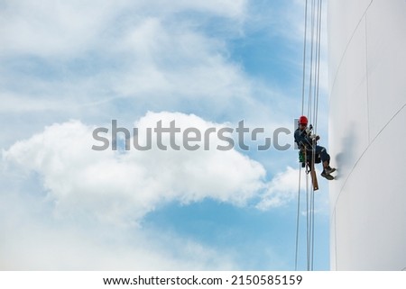 Male workers down height tank rope access inspection of thickness shell plate storage tank gas propane safety work at height. Royalty-Free Stock Photo #2150585159