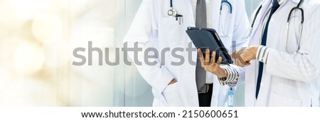 Male and female doctor, good looking, Asian, Thailand. Discussions are discussed in the hospital office about the patient's disease. web banner with copy space on left