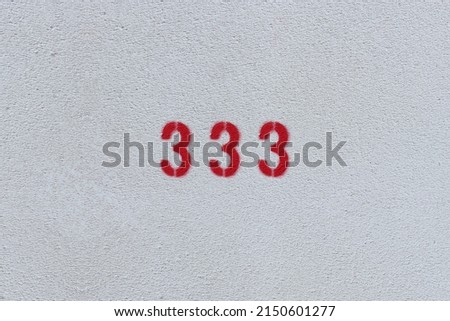 RED Number 333 on the white wall. Spray paint. 
