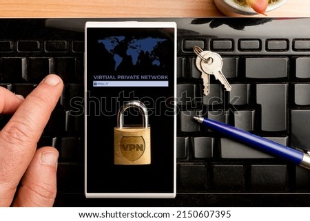 VPN (virtual private network) concept, man using a vpn software on a smartphone Royalty-Free Stock Photo #2150607395