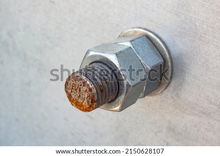Rusty bolt with two nuts close up