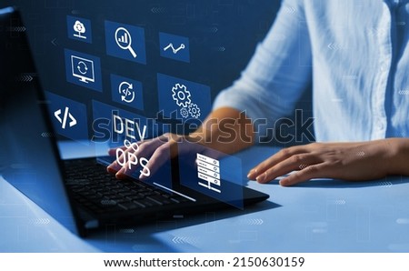  Engineer working on laptop with virtual screen. Agile programming and DevOps concept. IT operations, high software quality and software development. Royalty-Free Stock Photo #2150630159