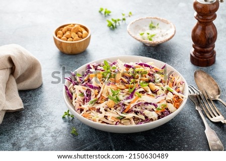 Asian cabbage cole slaw with peanut sauce, roasted peanuts and green onions Royalty-Free Stock Photo #2150630489