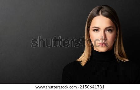 portrait of a beautiful girl's face looking at the camera with black background Royalty-Free Stock Photo #2150641731