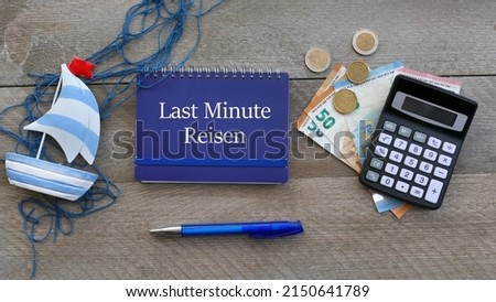 Calculator, notepad, euro bills with the text Last Minute Reise, Last Minute Reise  means translated last minute travel. Royalty-Free Stock Photo #2150641789
