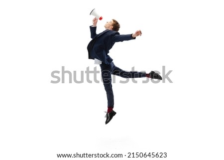 Studio shot of young male ballet dancer wearing business suit dancing isolated on white studio background. Business, start-up, art, work, caree, inspiration concept. Contemporary ballet dance. Copy