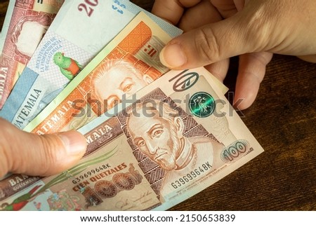 Guatemala money,  Lots of Quetzal banknotes handed over to another person