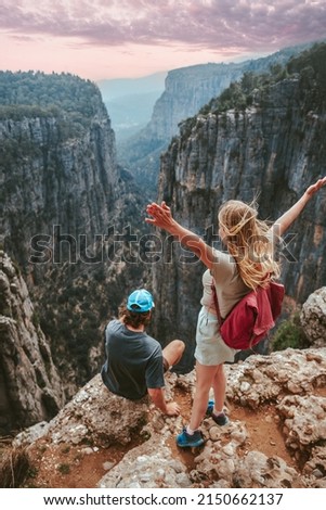 Couple on cliff Tazi canyon travel hiking together healthy lifestyle active summer vacations outdoor young man and woman tourists enjoying aerial view exploring Turkey Royalty-Free Stock Photo #2150662137