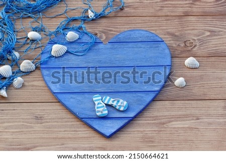 Maritime background: blue heart with shells, starfish and flip flop with space for text.