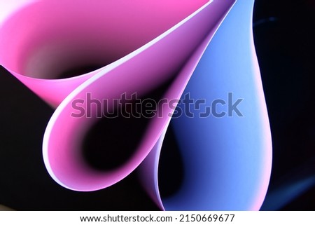 Fan of pink and blue colors of printable paper with geometric ellipses with incident light forms beautiful graphic design of light and shadow for backgrounds Royalty-Free Stock Photo #2150669677