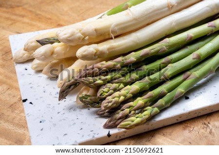 Bunch of fresh raw white and green asparagus vegetables, new season of asparagus Royalty-Free Stock Photo #2150692621