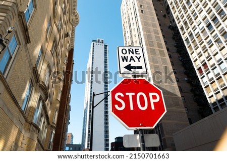 Stop sign in city street, with buildings and sky