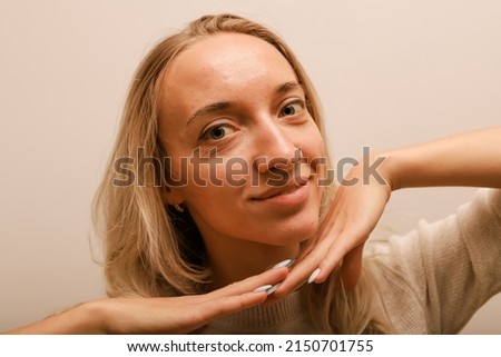 A young woman leaning on her hands smiles Royalty-Free Stock Photo #2150701755