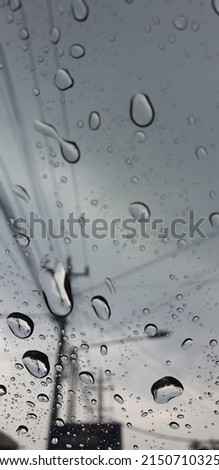 close up picture of rain drop in car front glass 