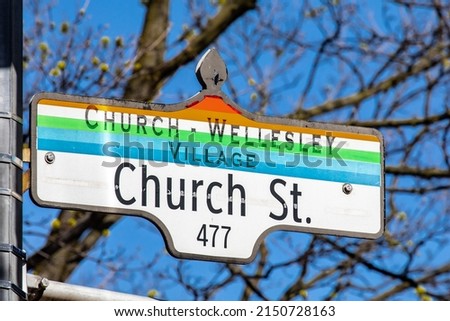 A street sign for Church Street with the rainbow color scheme indicating a street in the Church Wellesley gay village in Toronto.