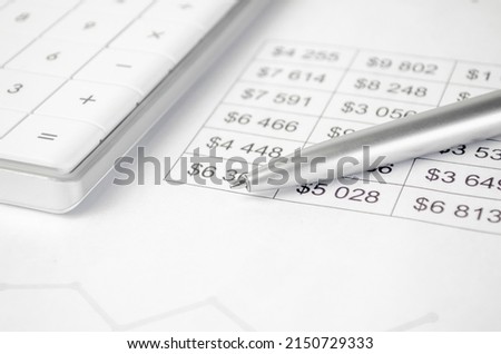 Financial accounting, budgeting, stock market concept. Pen and calculator on sales report