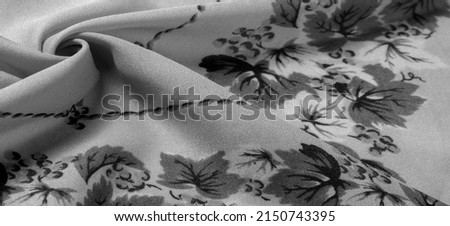 Silk fabric. crepe de chin. The color is black, the flowers are gray. It is a group of silk characterized by roughness and also slightly wrinkled.