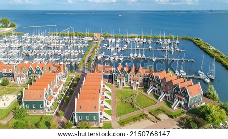 Aerial drone view of typical modern Dutch houses and marina in harbor from above, architecture of port of Volendam town, North Holland, Netherlands Royalty-Free Stock Photo #2150768147
