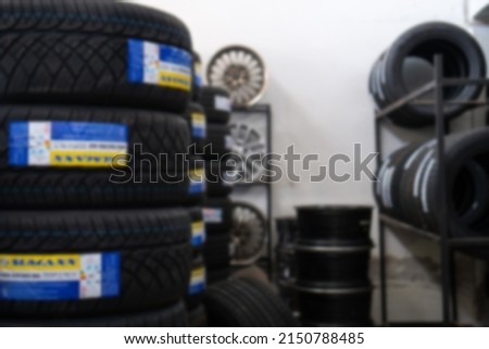 Tires are placed on the floor. In the warehouse. Blur the focus.
