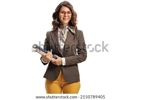 Young female teacher with glasses holding books isolated on white background