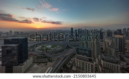Sunrise over Dubai marina and JLT skyscrapers along Sheikh Zayed Road aerial morning timelapse. Residential and office buildings from above. Orange sky above golf course Royalty-Free Stock Photo #2150803645